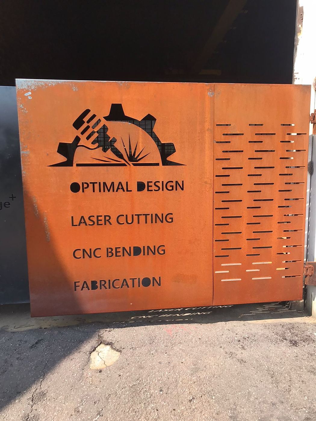 Orange laser-cut steel signage panel