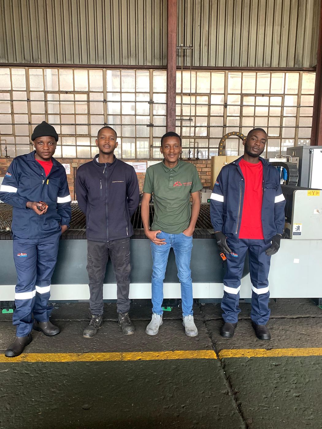 The IK Plus team outside the workshop